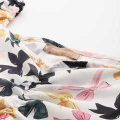 Cropped v-neck peplum puff sleeved top with digital print on linen fabric.